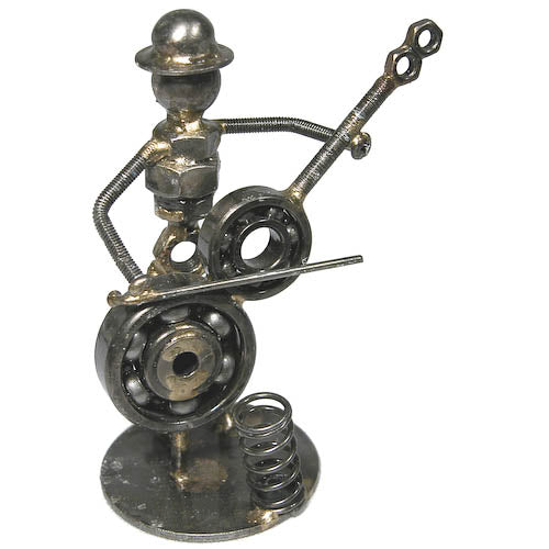 A whimsical Cello Player Junkyard Pen Holder made from salvaged metal scraps, showcasing creativity and craftsmanship.