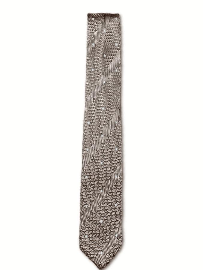 Champagne gold knitted tie with white polka dots, showcasing a luxurious silk texture and pointed end design.