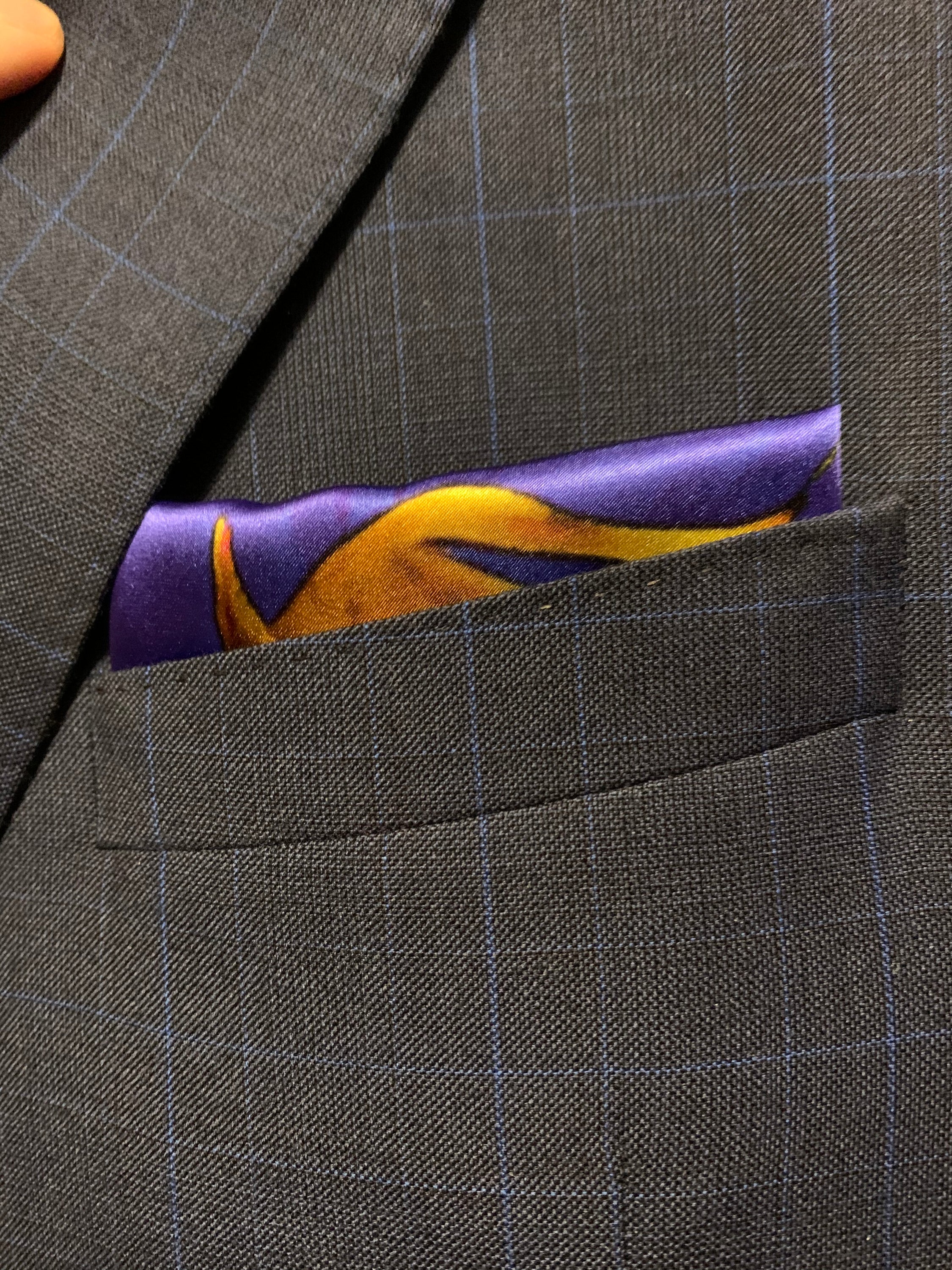 A vibrant blue and yellow pocket square featuring a bold design, symbolizing optimism and strength, perfect for stylish gentlemen.