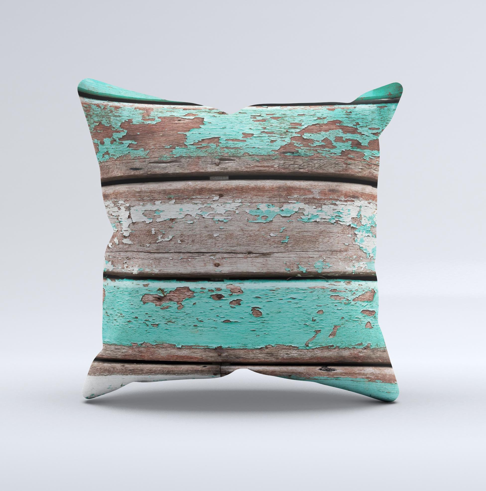 Chipped teal paint on wood decorative throw pillow, handcrafted with high thread count fabric and unique design.