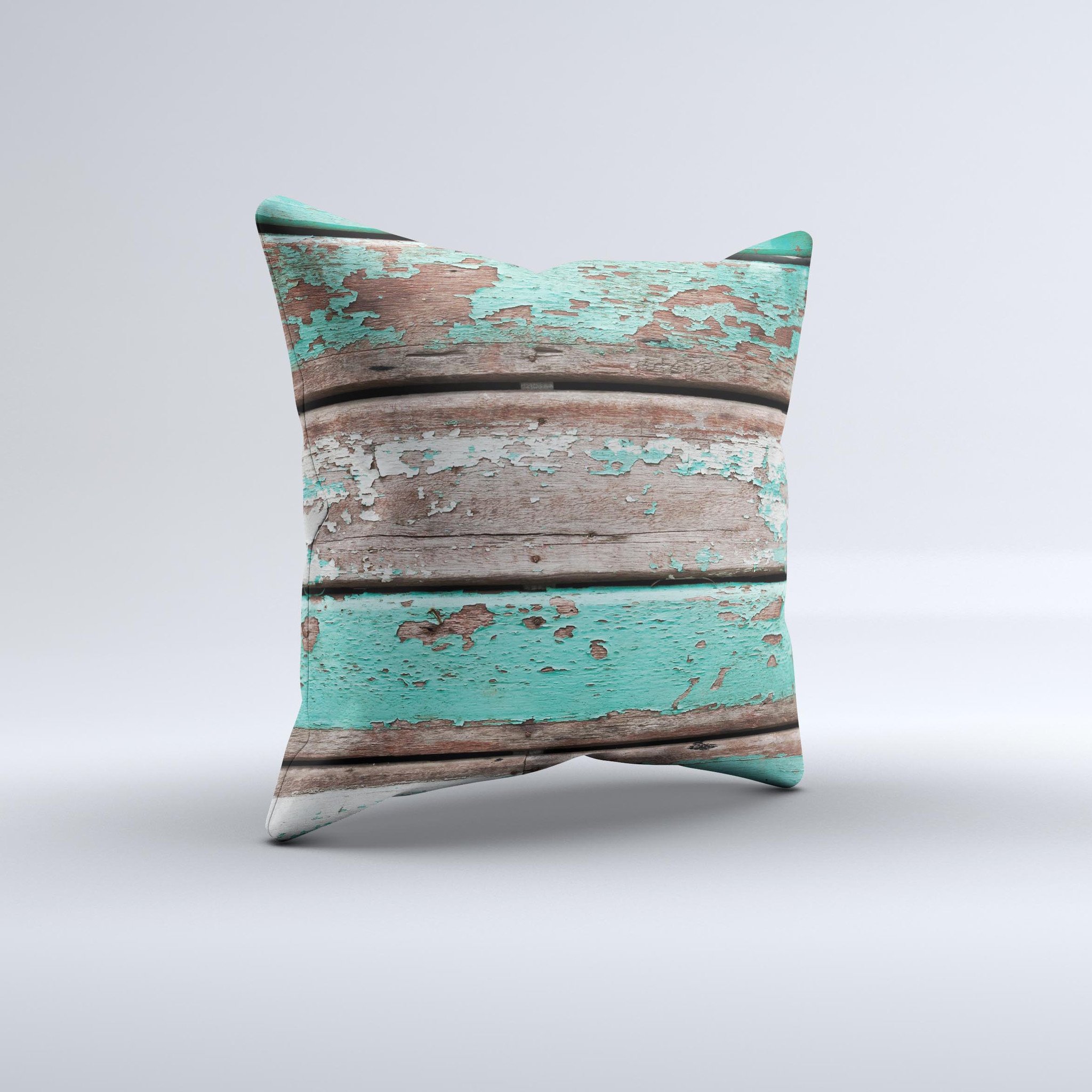 Chipped teal paint on wood decorative throw pillow, handcrafted with high thread count fabric and unique design.