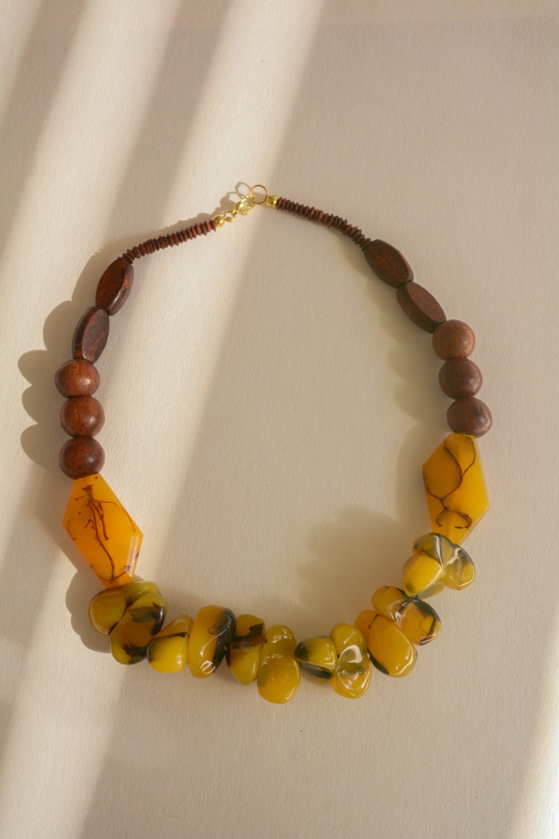 Chunky amber resin beaded necklace featuring vibrant, colorful beads, perfect for adding style to any outfit.