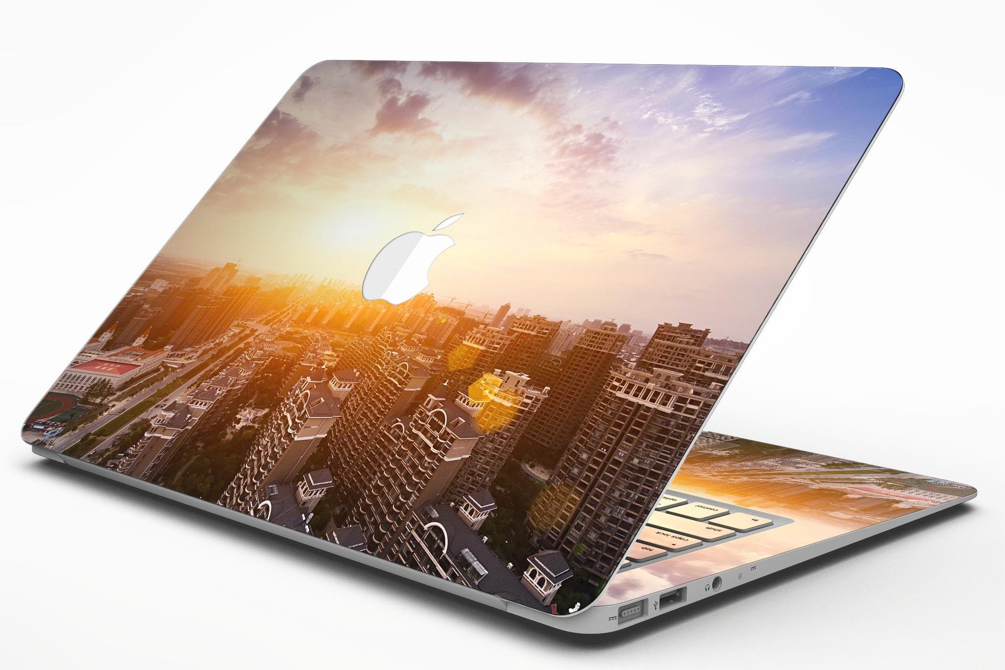 Cityscape at Sunset MacBook Air Skin Kit showcasing vibrant sunset colors and city skyline design.