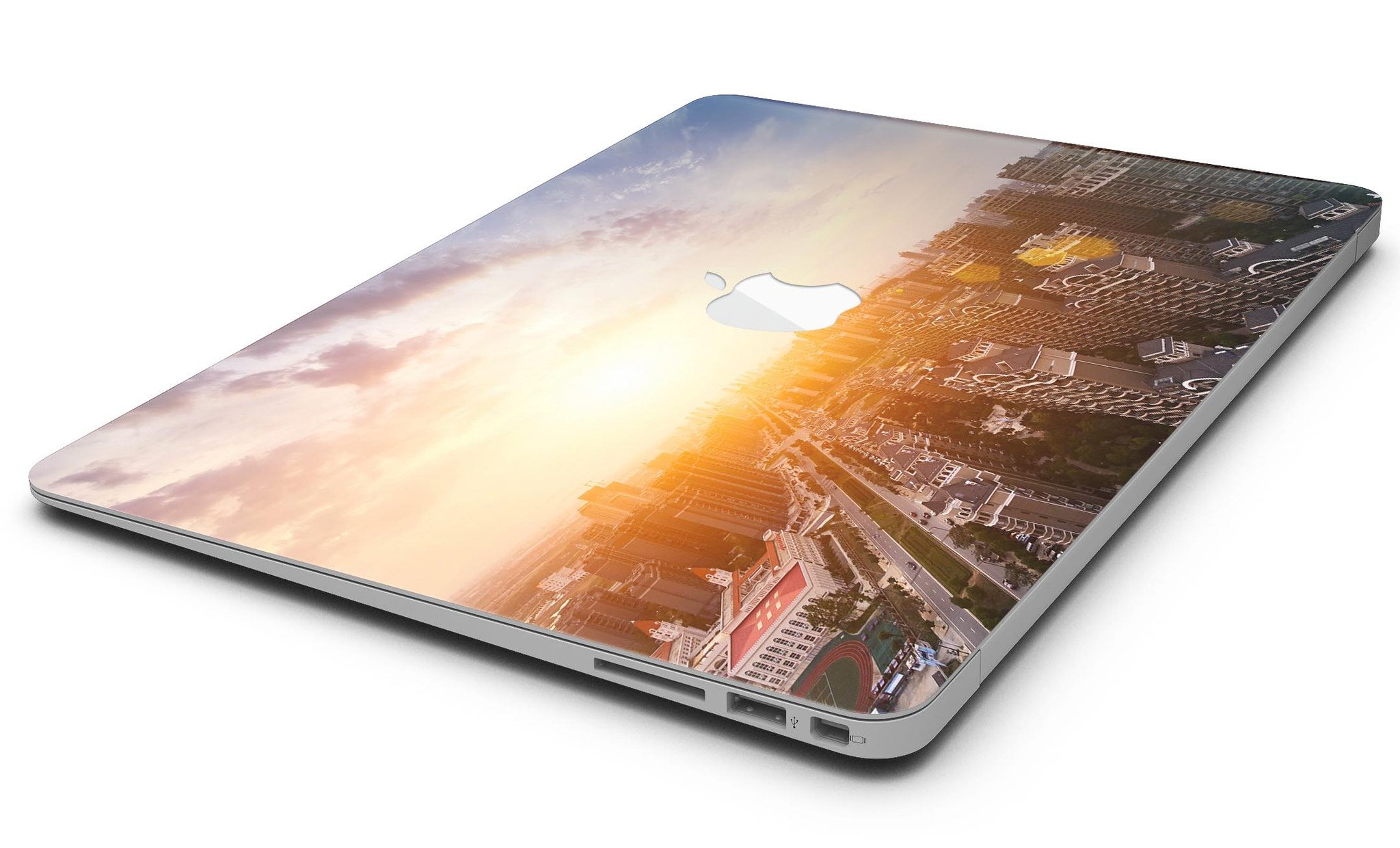 Cityscape at Sunset MacBook Air Skin Kit showcasing vibrant sunset colors and city skyline design.