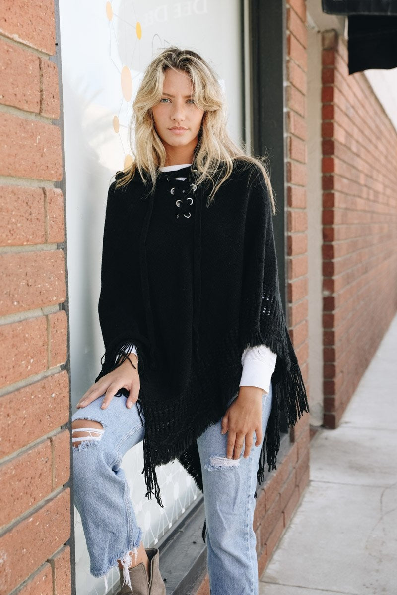 A stylish Classic Knit Hooded Poncho in a cozy knit fabric, featuring a hood and a loose fit, perfect for casual or dressy outfits.