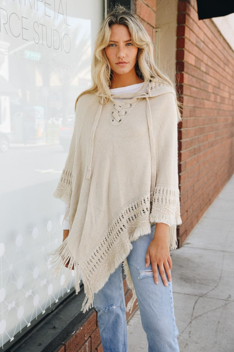 A stylish Classic Knit Hooded Poncho in a cozy knit fabric, featuring a hood and a loose fit, perfect for casual or dressy outfits.