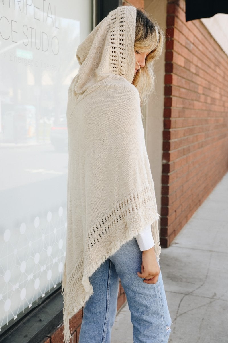 A stylish Classic Knit Hooded Poncho in a cozy knit fabric, featuring a hood and a loose fit, perfect for casual or dressy outfits.