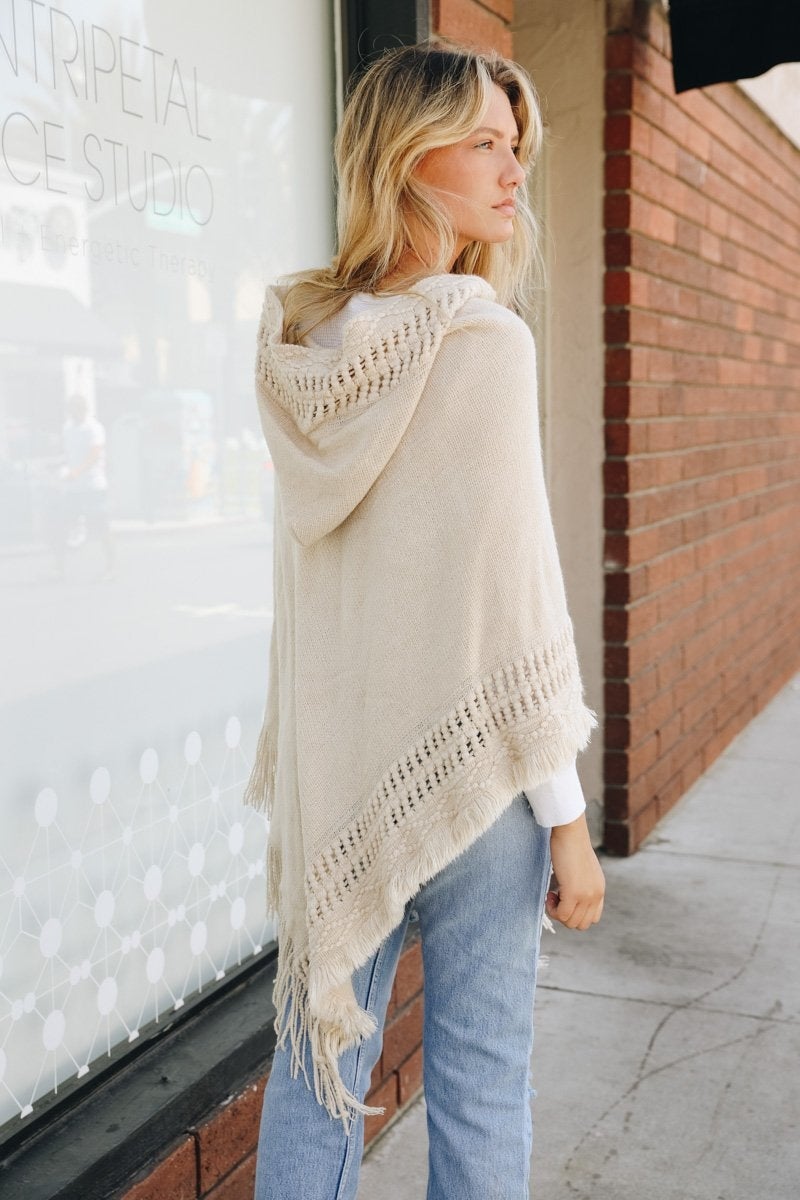 A stylish Classic Knit Hooded Poncho in a cozy knit fabric, featuring a hood and a loose fit, perfect for casual or dressy outfits.