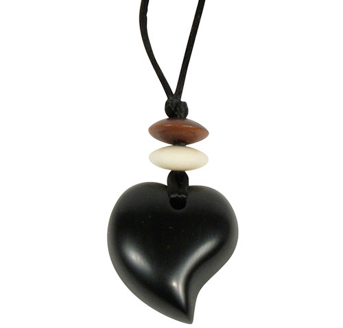 Handcrafted Coal Raindrop Pendant with tagua beads on a black cord, symbolizing fair trade and artisan craftsmanship.