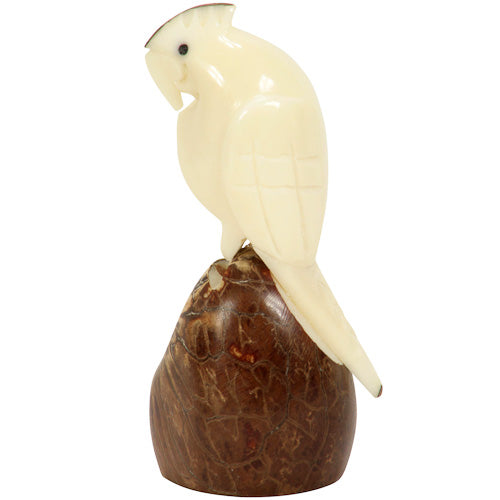 Hand-carved cockatoo figurine made from tagua nuts, showcasing intricate details and natural colors, symbolizing eco-friendly craftsmanship.