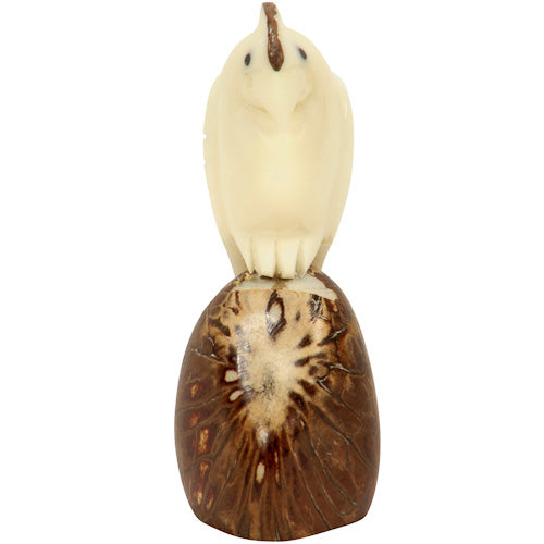 Hand-carved cockatoo figurine made from tagua nuts, showcasing intricate details and natural colors, symbolizing eco-friendly craftsmanship.