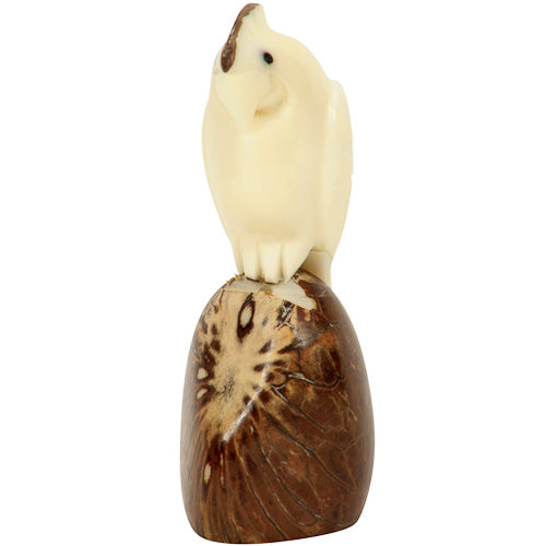 Hand-carved cockatoo figurine made from tagua nuts, showcasing intricate details and natural colors, symbolizing eco-friendly craftsmanship.