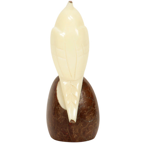 Hand-carved cockatoo figurine made from tagua nuts, showcasing intricate details and natural colors, symbolizing eco-friendly craftsmanship.