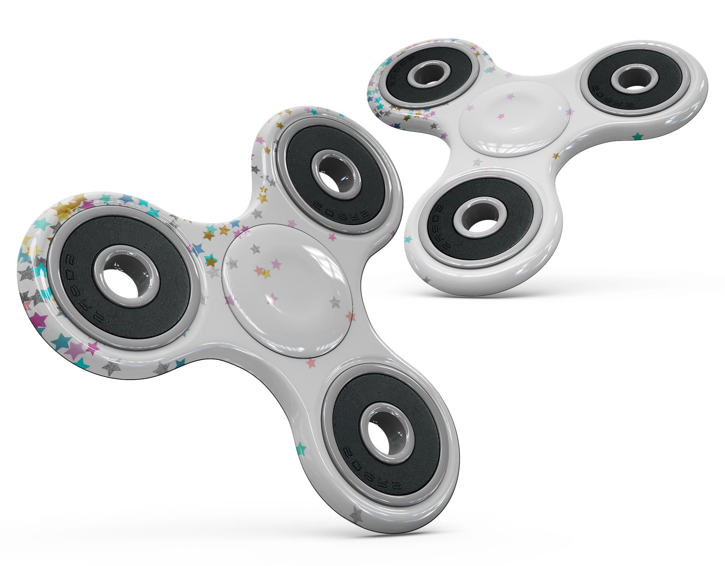 Colorful falling stars design on a white fidget spinner skin kit, showcasing vibrant colors and a stylish pattern.