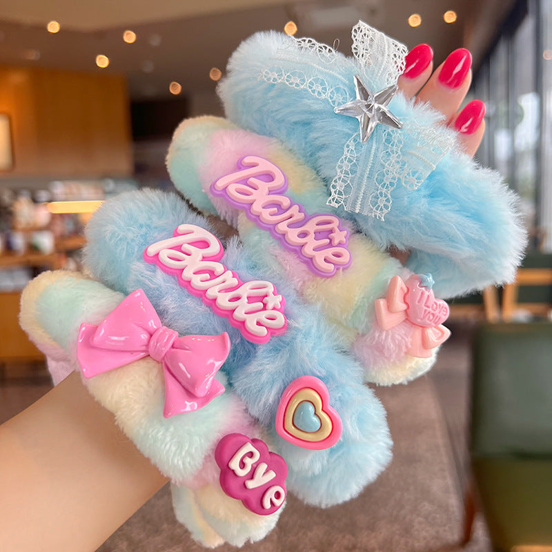 A vibrant set of four plush Barbie hair scrunchies in various playful designs, perfect for adding color to hairstyles.