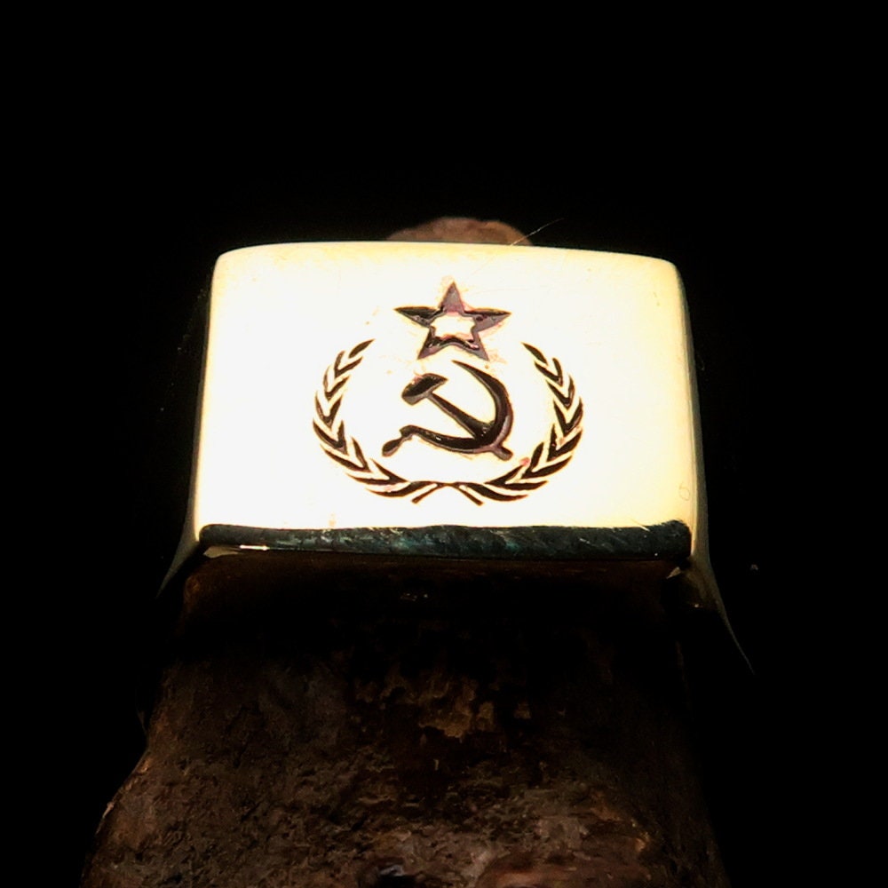 A square-shaped Communist Costume Ring with a red Hammer and Sickle design, crafted from polished brass, ideal for pinky fingers.