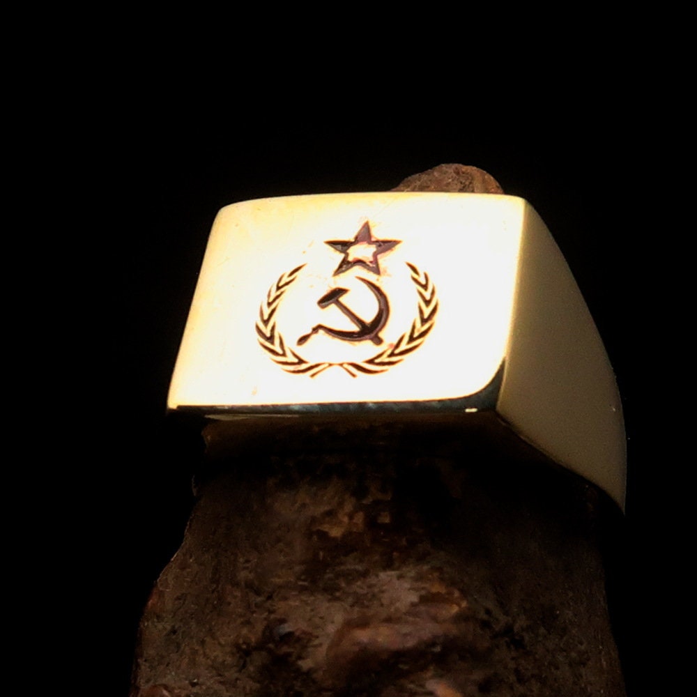 A square-shaped Communist Costume Ring with a red Hammer and Sickle design, crafted from polished brass, ideal for pinky fingers.