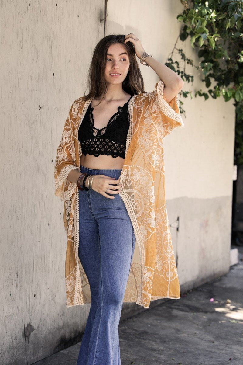 A lightweight embroidered kimono featuring contrast mesh and lace details, perfect for a boho-chic style in spring and summer.