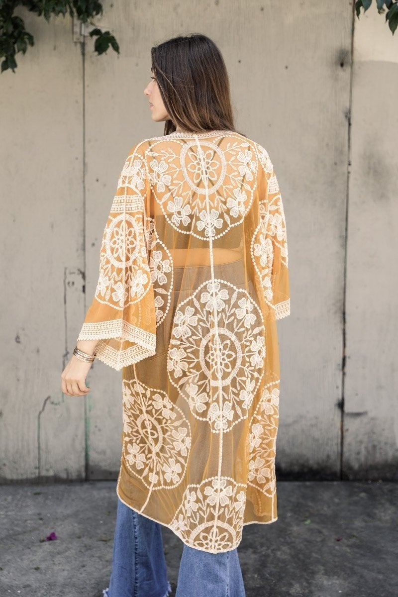 A lightweight embroidered kimono featuring contrast mesh and lace details, perfect for a boho-chic style in spring and summer.