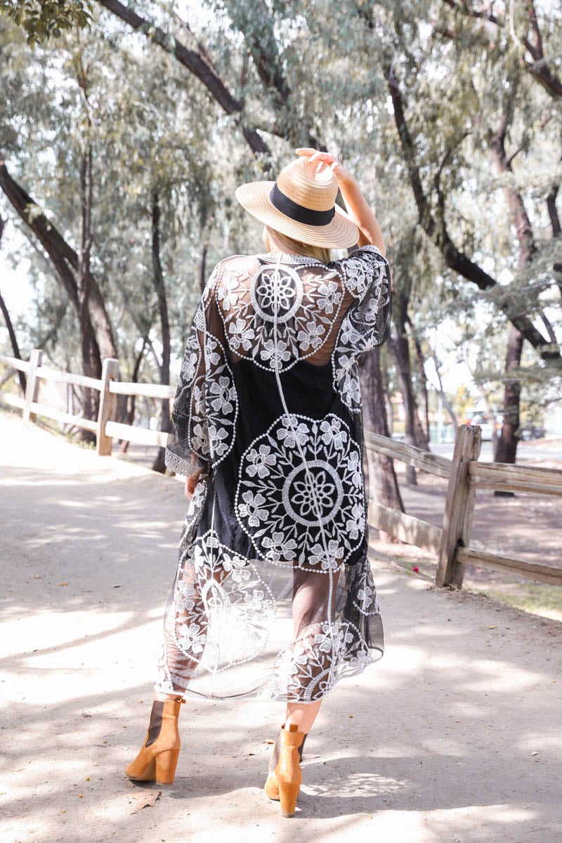 A lightweight embroidered kimono featuring contrast mesh and lace details, perfect for a boho-chic style in spring and summer.