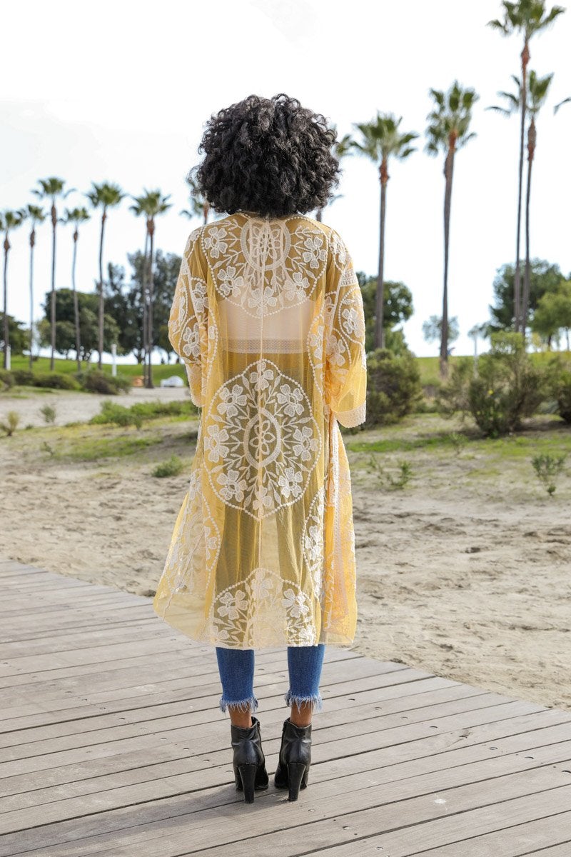 A lightweight embroidered kimono featuring contrast mesh and lace details, perfect for a boho-chic style in spring and summer.