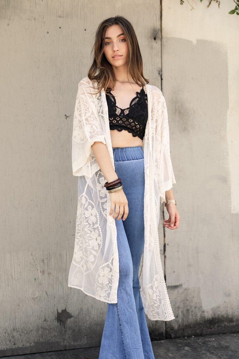 A lightweight embroidered kimono featuring contrast mesh and lace details, perfect for a boho-chic style in spring and summer.