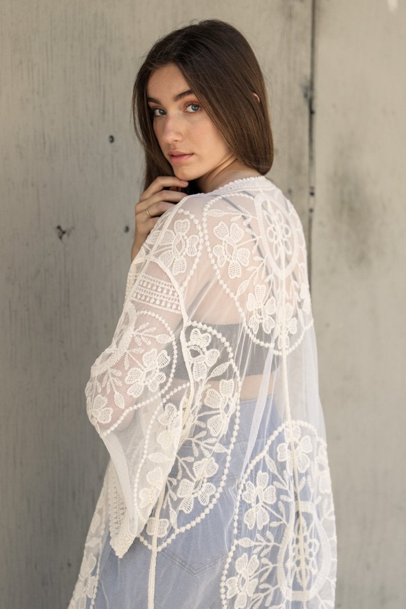 A lightweight embroidered kimono featuring contrast mesh and lace details, perfect for a boho-chic style in spring and summer.