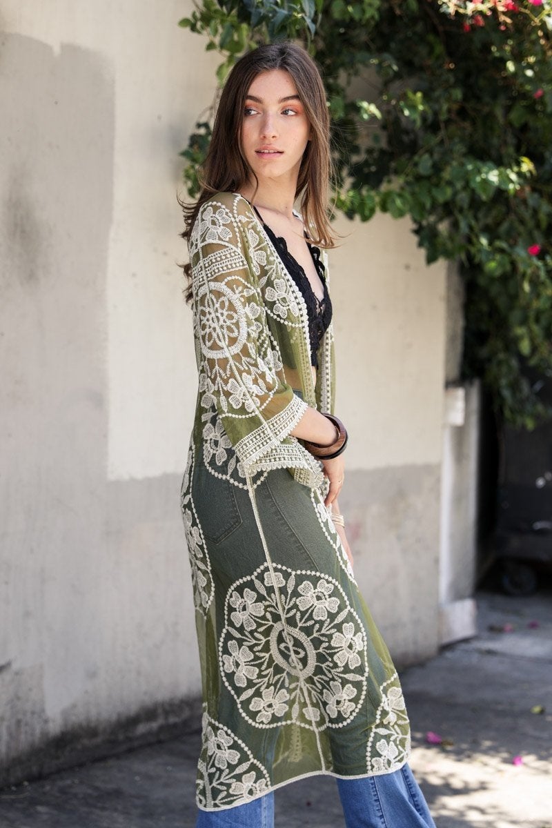 A lightweight embroidered kimono featuring contrast mesh and lace details, perfect for a boho-chic style in spring and summer.