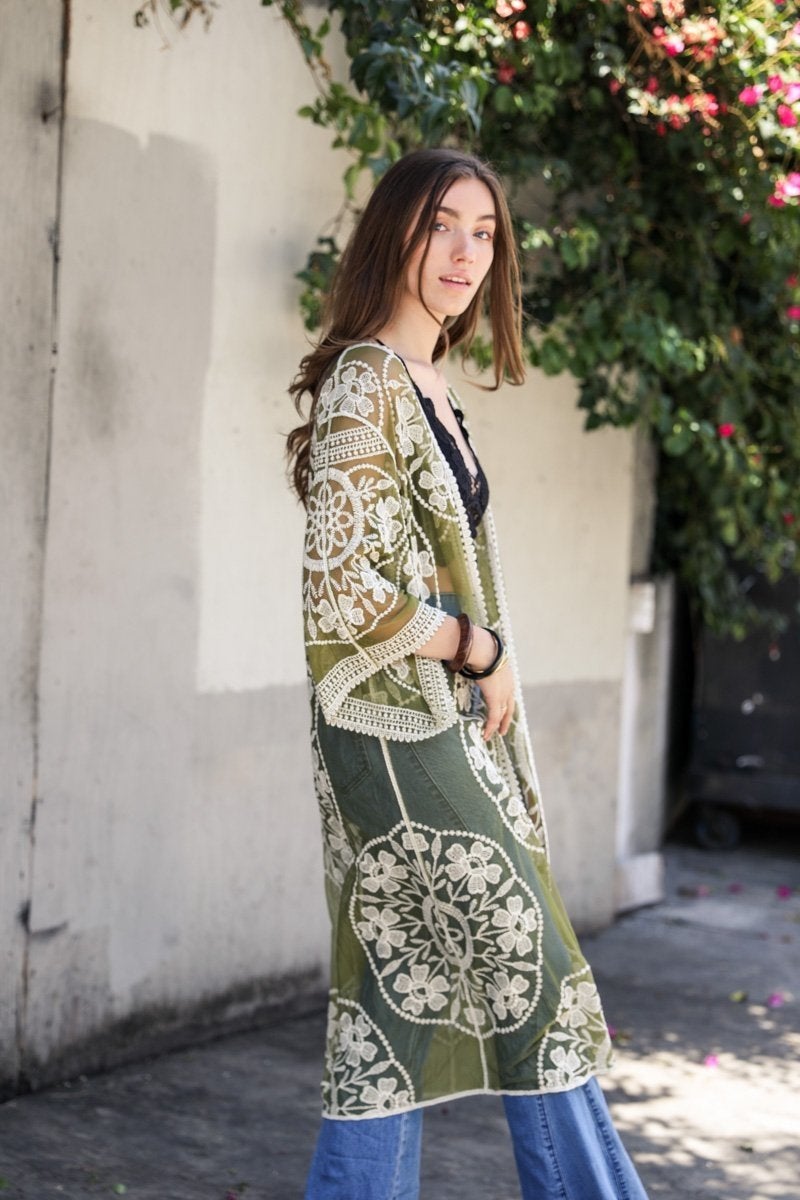 A lightweight embroidered kimono featuring contrast mesh and lace details, perfect for a boho-chic style in spring and summer.