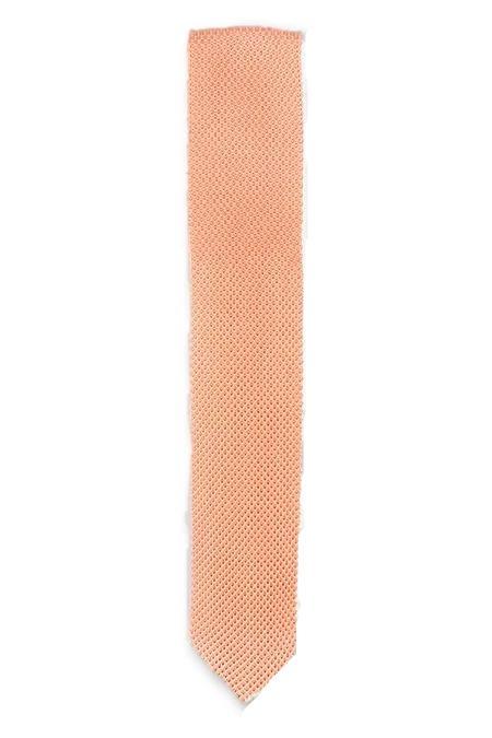 Coral Fusion Knitted Tie with a pointed end, showcasing a vibrant coral color and textured knit design.