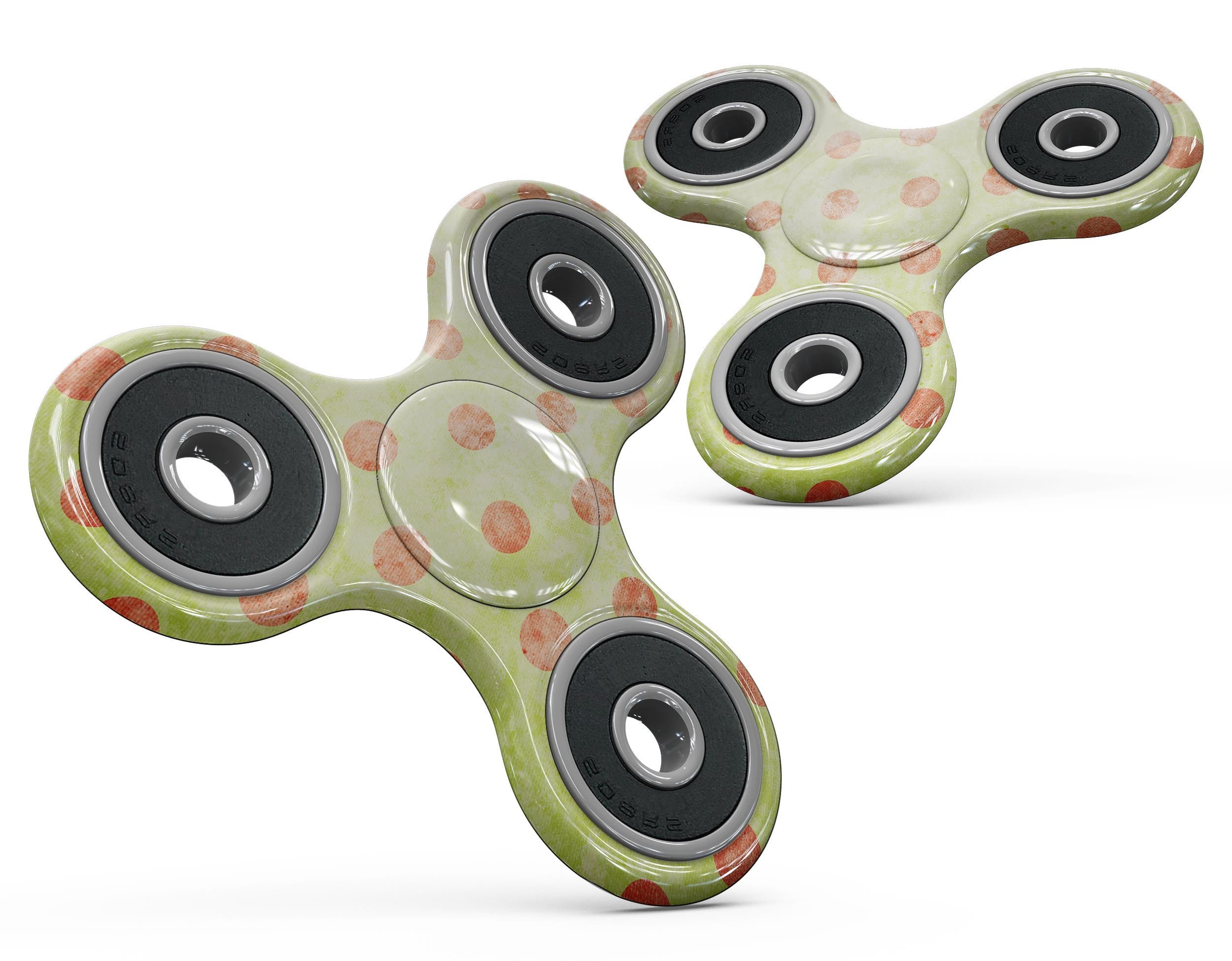 Coral polka dots design over a grunge yellow background on a fidget spinner skin kit, showcasing vibrant colors and a stylish pattern.