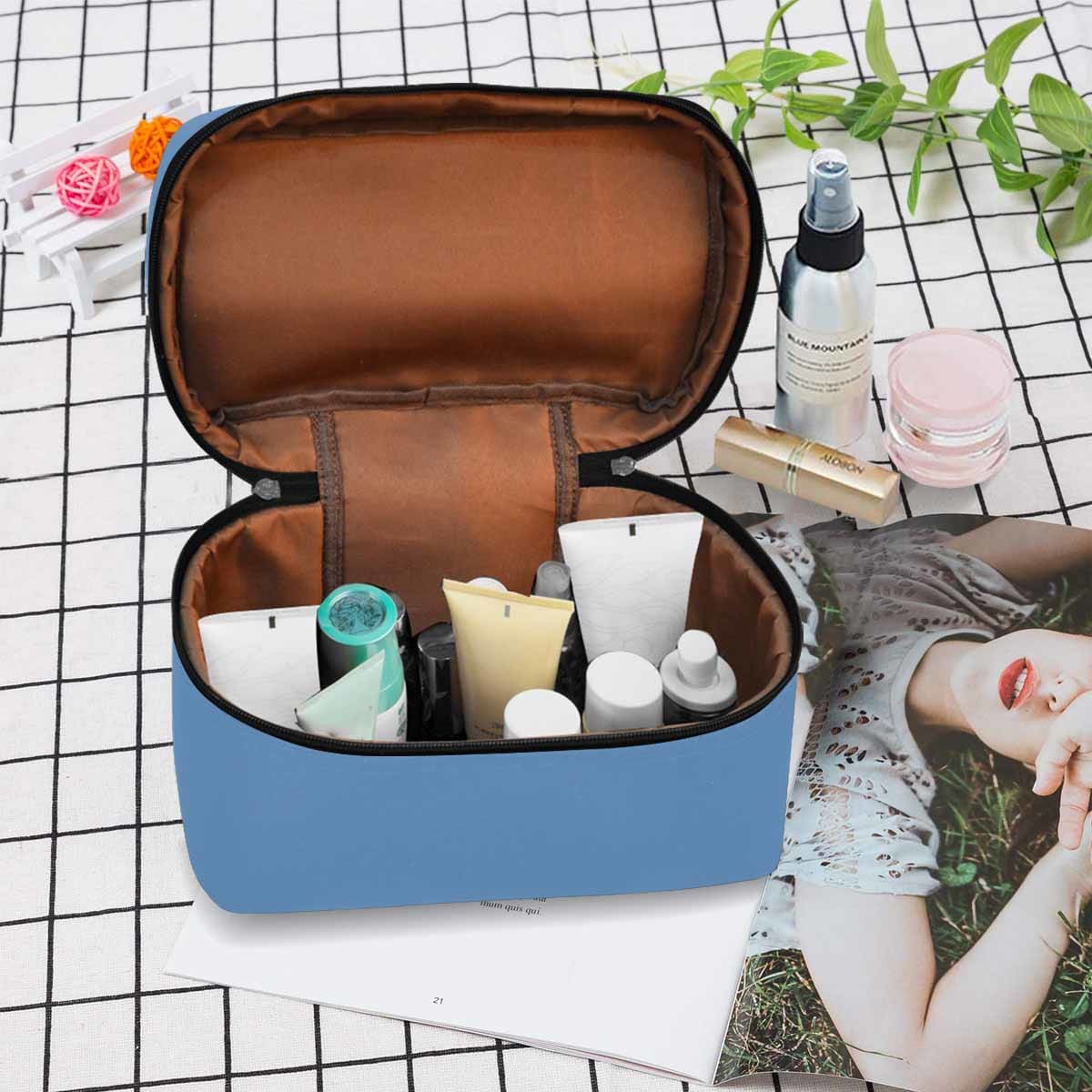 Stylish blue gray cosmetic bag with multiple compartments, perfect for organizing beauty essentials.