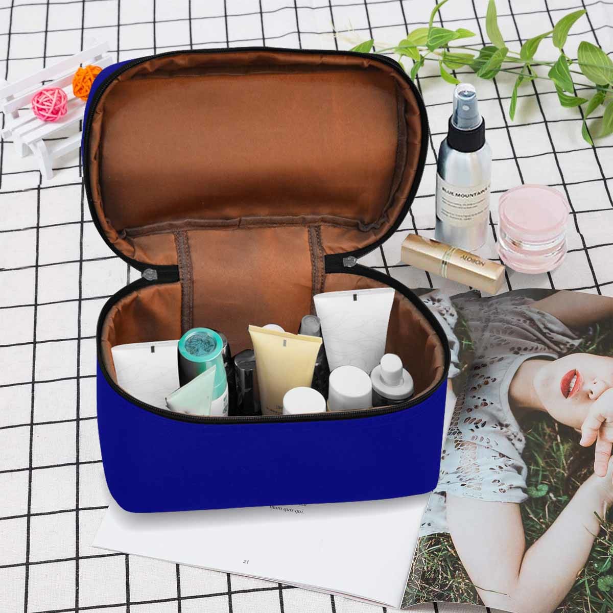 Stylish dark blue cosmetic bag with multiple compartments and secure zipper closure, perfect for travel and daily use.