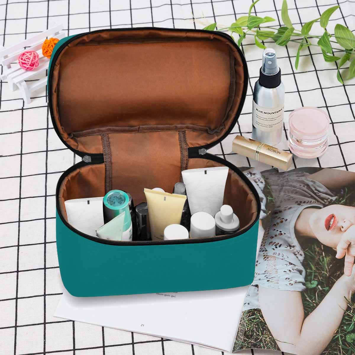 Dark teal green cosmetic bag with multiple compartments and secure zipper closure, perfect for travel and organization.