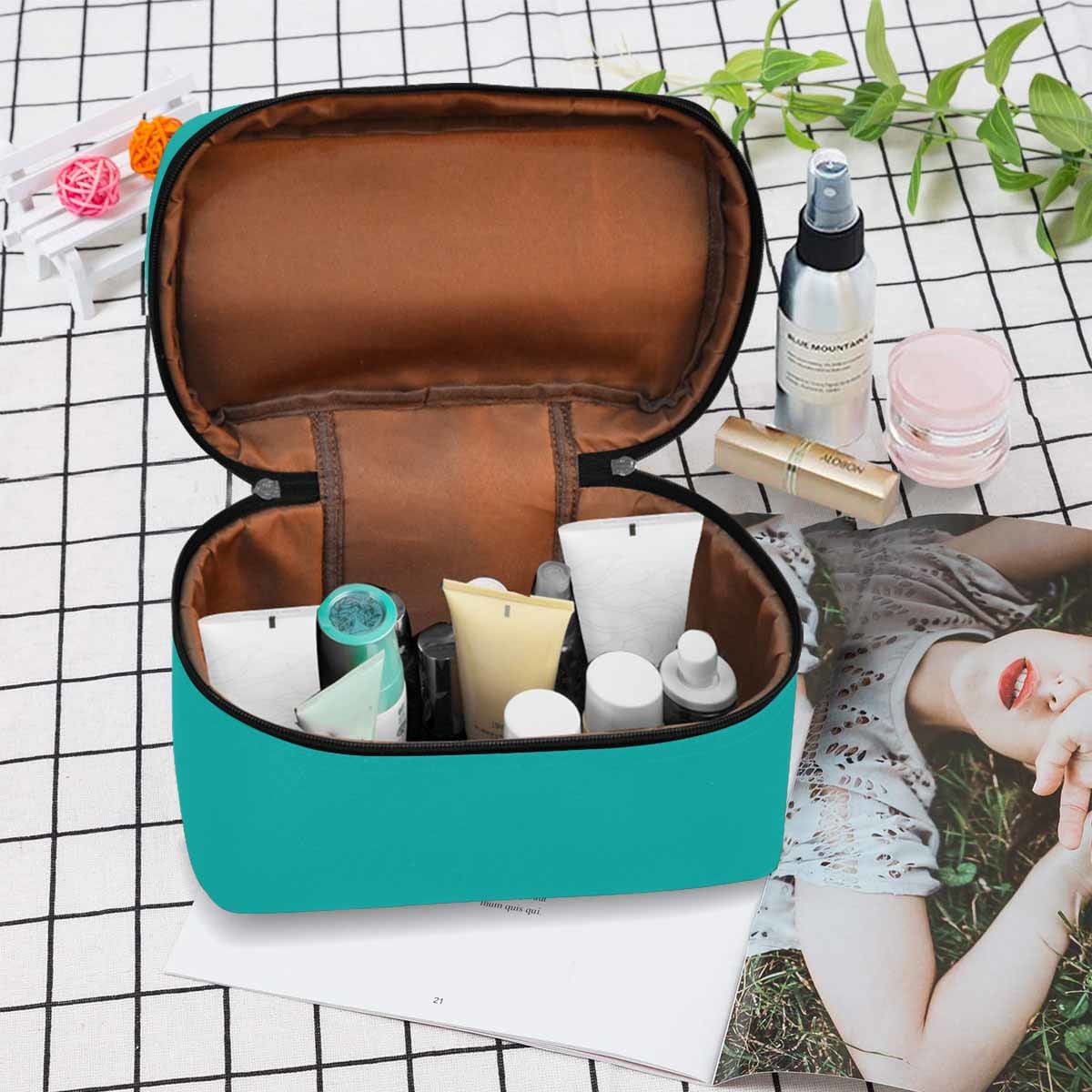 Stylish greenish blue cosmetic bag with multiple compartments and secure zipper closure, perfect for travel and organization.