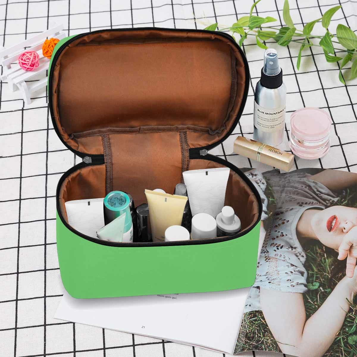 Pastel green cosmetic bag with multiple compartments and secure zipper closure, ideal for travel and organization.