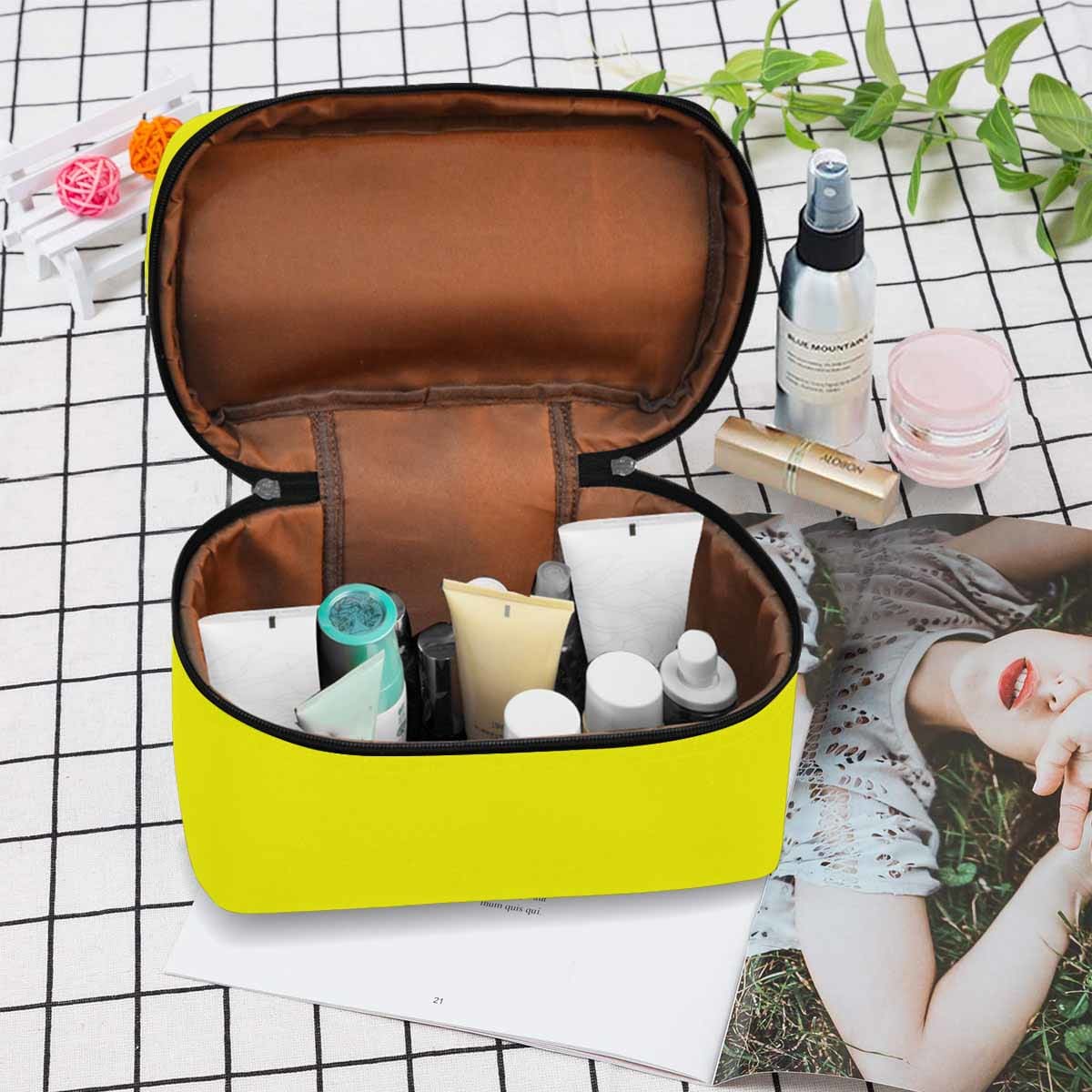 Stylish yellow cosmetic bag with multiple compartments and secure zipper closure, perfect for organizing beauty essentials.