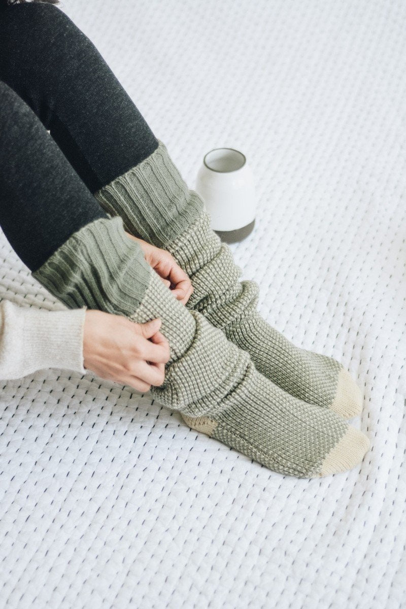 A pair of Cozy Ribbed Knit Lounge Socks in a soft acrylic material, featuring a stylish ribbed design, perfect for chilly days.