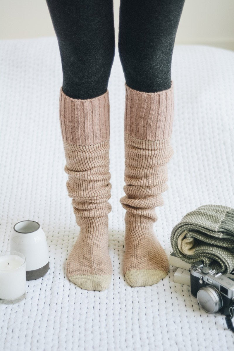 A pair of Cozy Ribbed Knit Lounge Socks in a soft acrylic material, featuring a stylish ribbed design, perfect for chilly days.