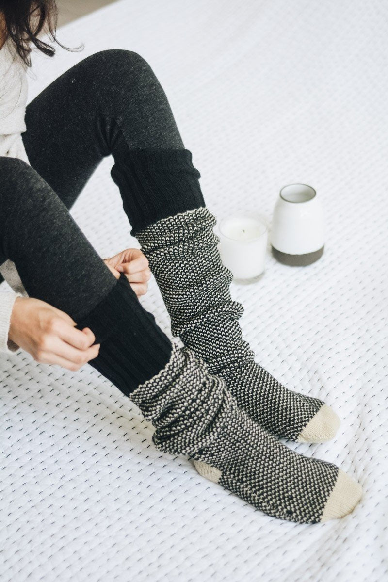 A pair of Cozy Ribbed Knit Lounge Socks in a soft acrylic material, featuring a stylish ribbed design, perfect for chilly days.