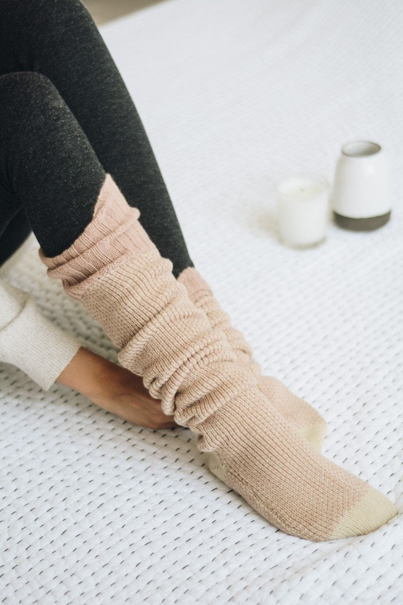 A pair of Cozy Ribbed Knit Lounge Socks in a soft acrylic material, featuring a stylish ribbed design, perfect for chilly days.