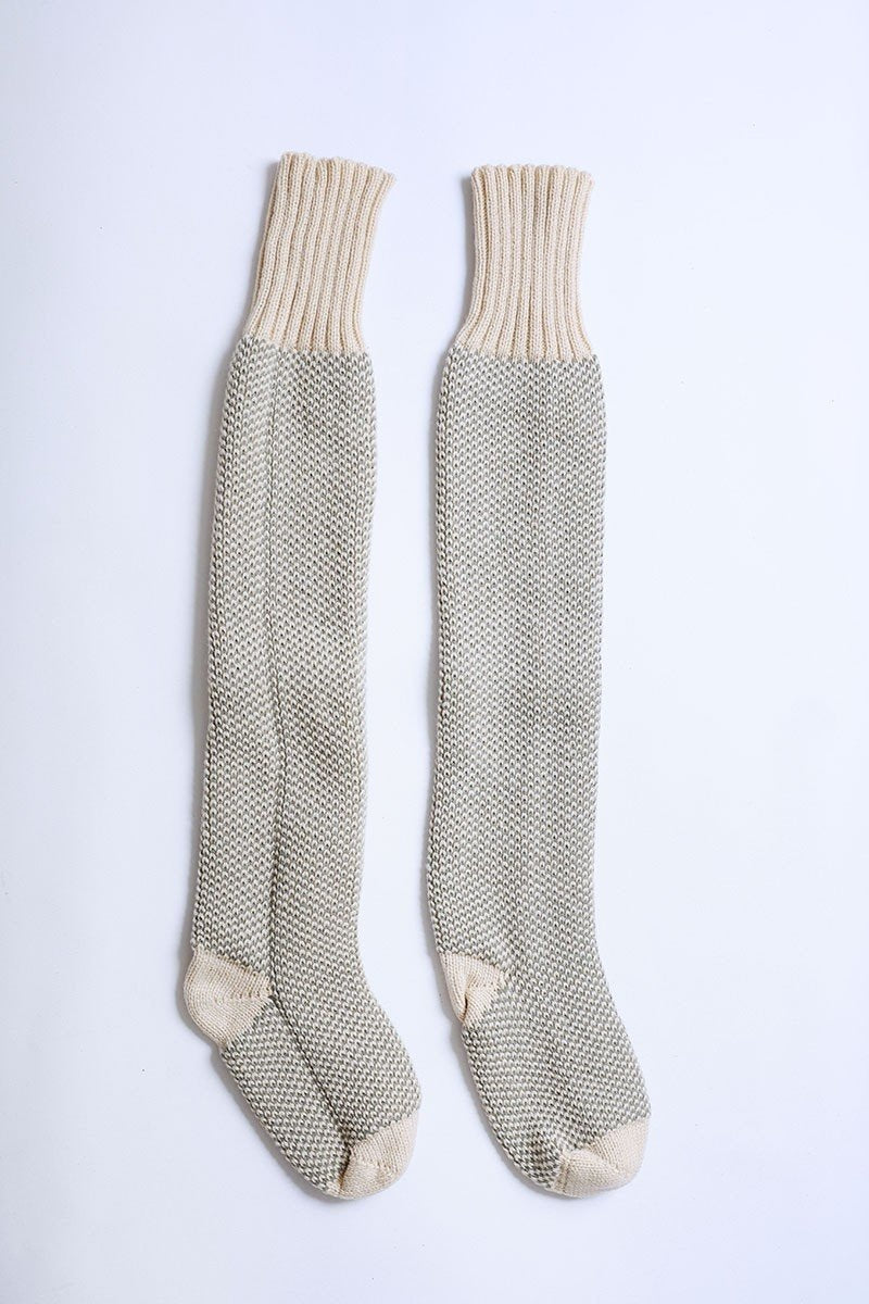 A pair of Cozy Ribbed Knit Lounge Socks in a soft acrylic material, featuring a stylish ribbed design, perfect for chilly days.