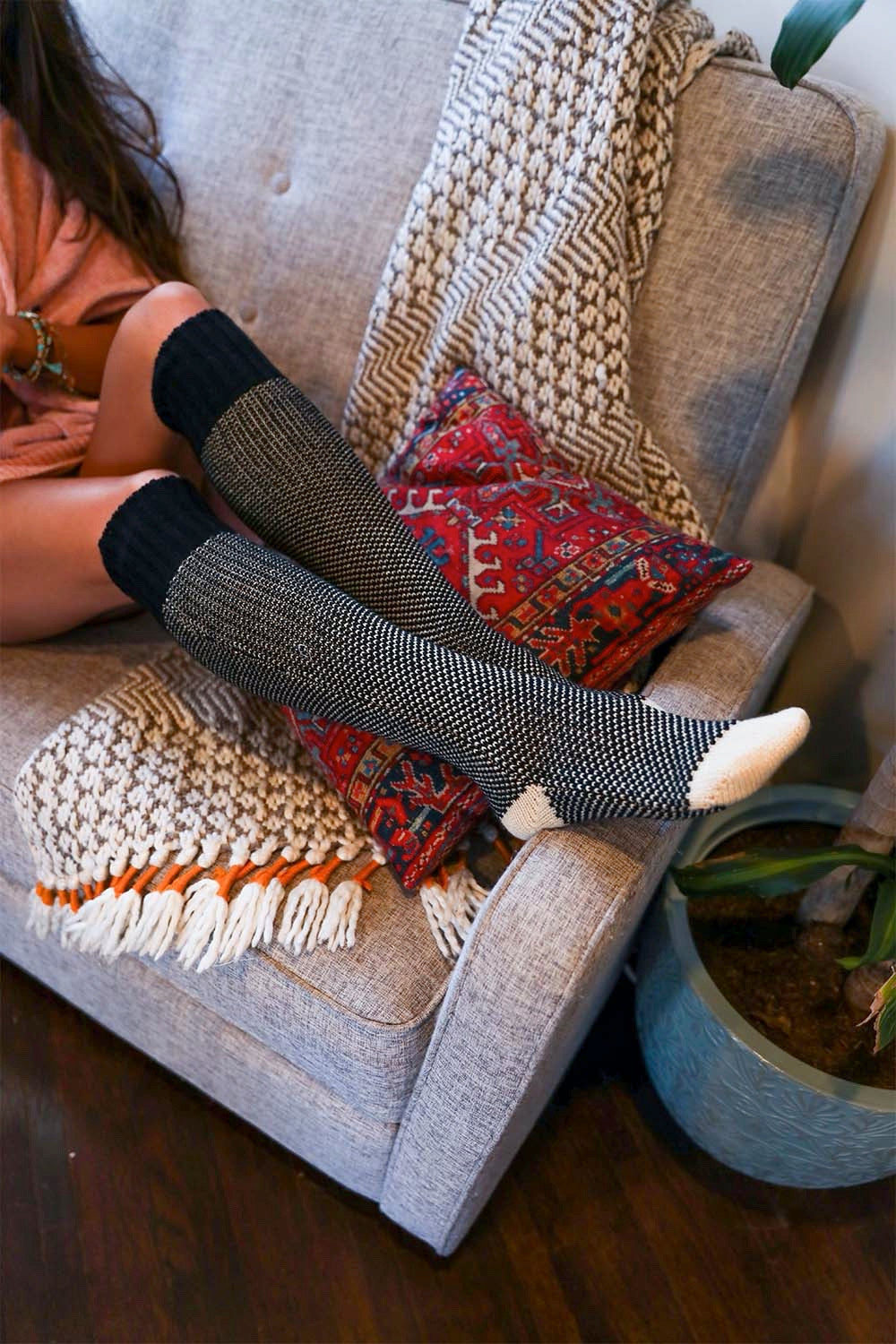 A pair of Cozy Ribbed Knit Lounge Socks in a soft acrylic material, featuring a stylish ribbed design, perfect for chilly days.