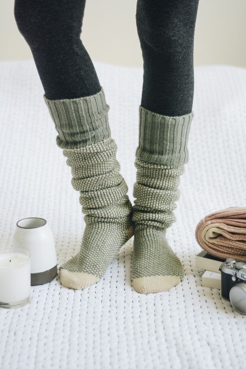 A pair of Cozy Ribbed Knit Lounge Socks in a soft acrylic material, featuring a stylish ribbed design, perfect for chilly days.