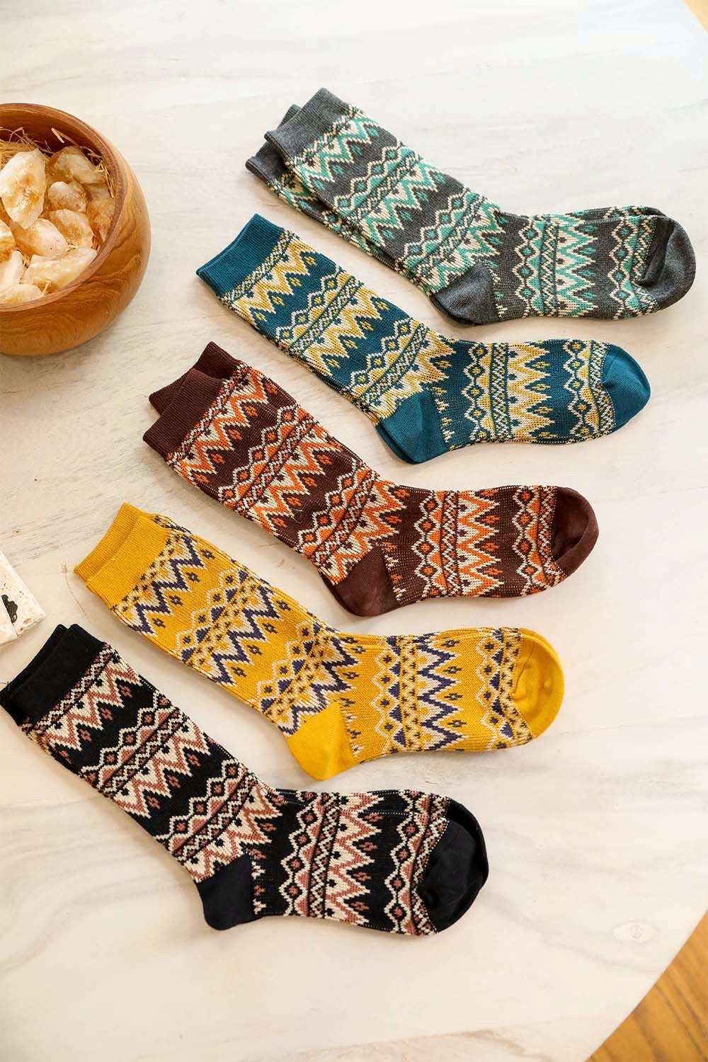 A pair of cozy tribal pattern socks featuring a warm and fuzzy texture, perfect for winter wear.