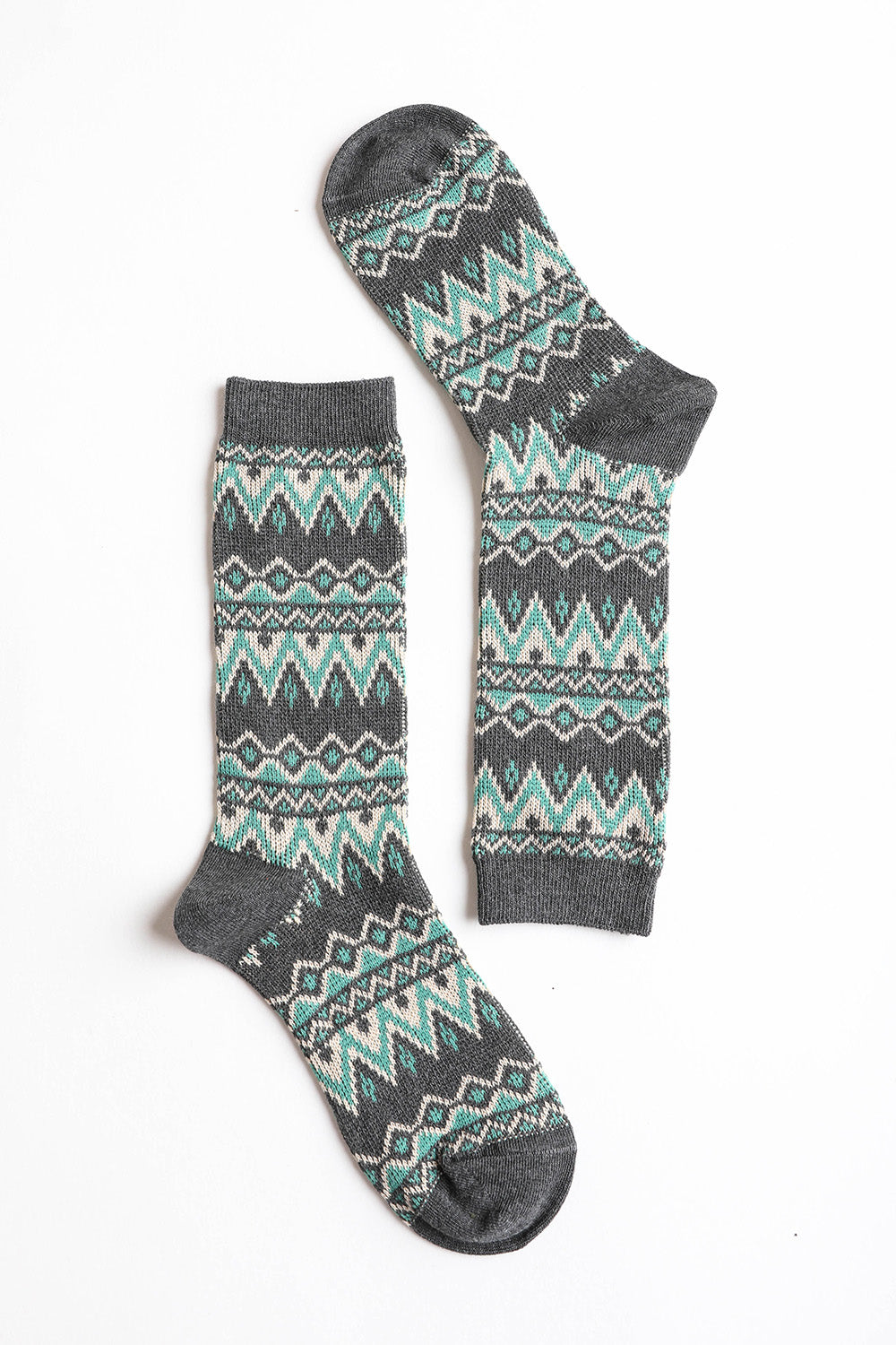 A pair of cozy tribal pattern socks featuring a warm and fuzzy texture, perfect for winter wear.