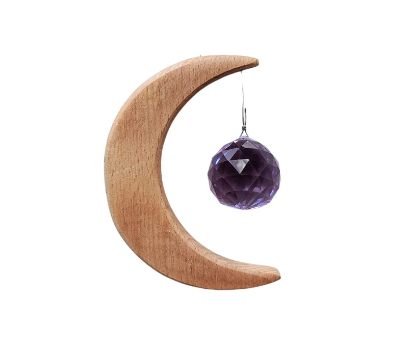 Crescent Moon Rainbow Maker featuring a purple prism and wooden crescent moon with 'Shine your Light' inscription, hanging in a sunlit window.