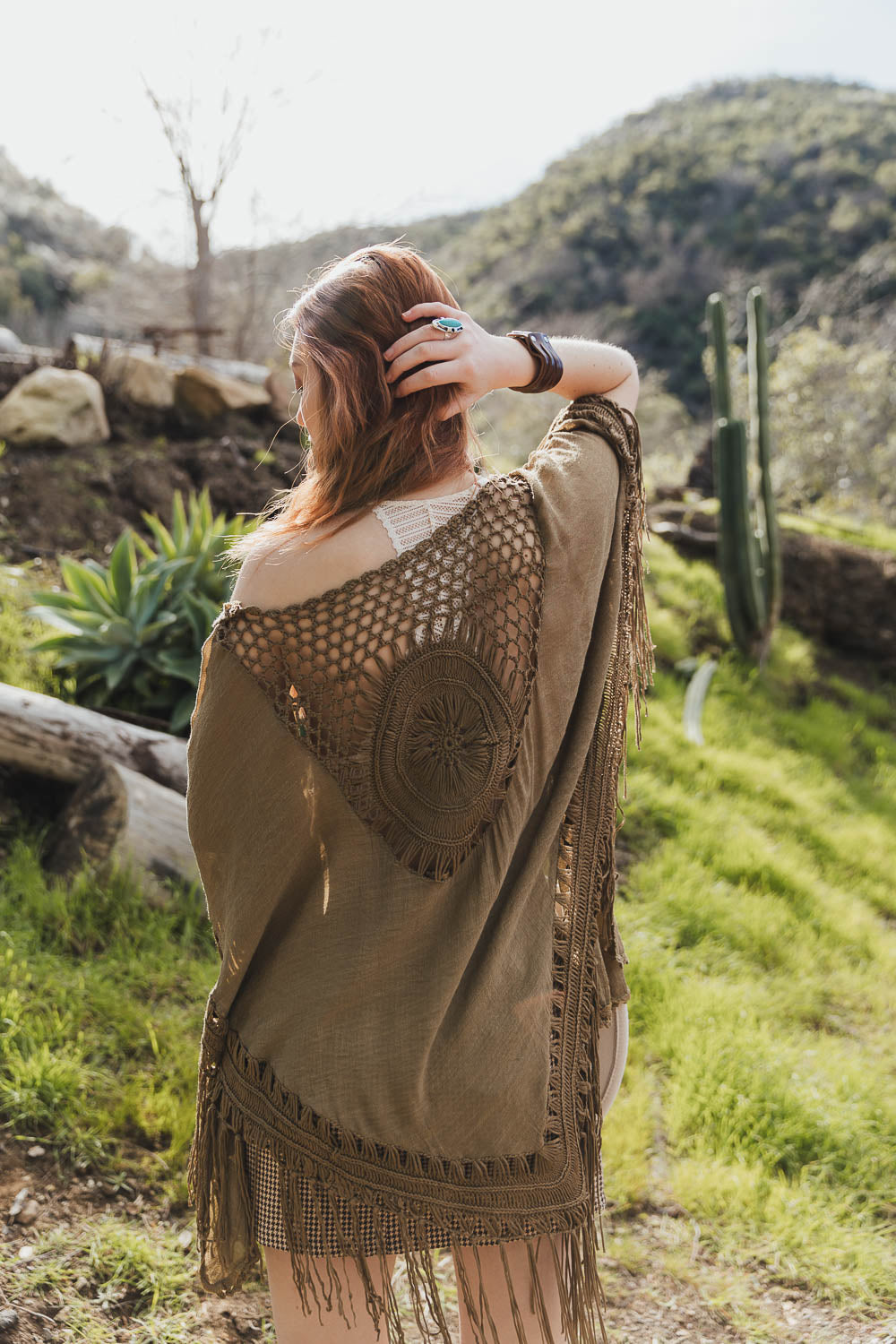 A stylish Crochet Medallion Tassel Kimono featuring intricate crochet patterns and playful tassels, perfect for summer outfits.