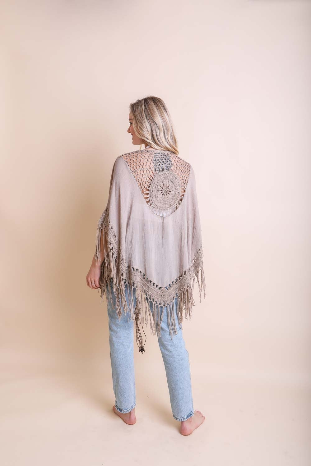 A lightweight Crochet Medallion Tassel Kimono featuring intricate crochet patterns and tassels, perfect for a bohemian look.