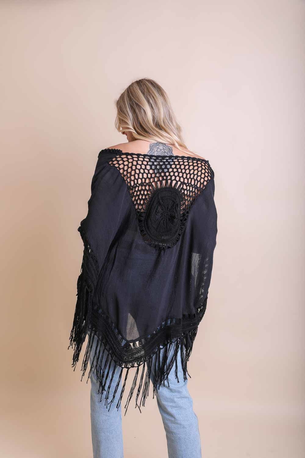 A lightweight Crochet Medallion Tassel Kimono featuring intricate crochet patterns and tassels, perfect for a bohemian look.